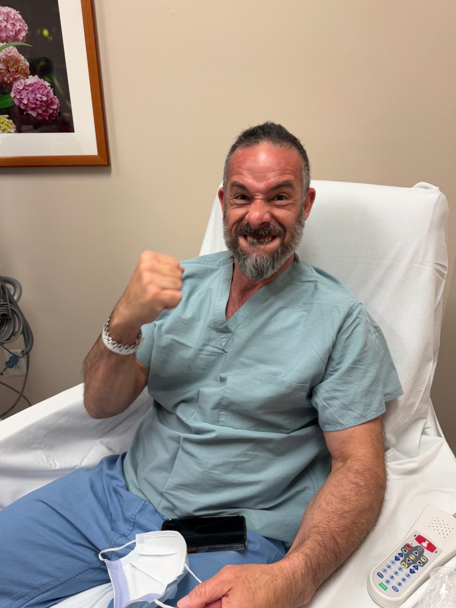 Luis during treatment, raising his fist with a smile
